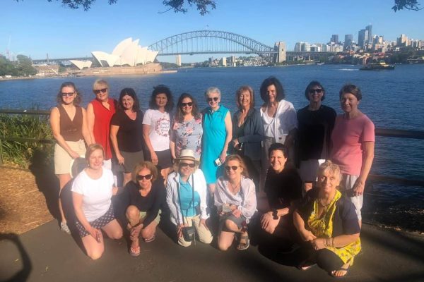 A wonderful group of women pose together with the Sydney Opera House behind them during Womens Travel Network's Australia tour for women